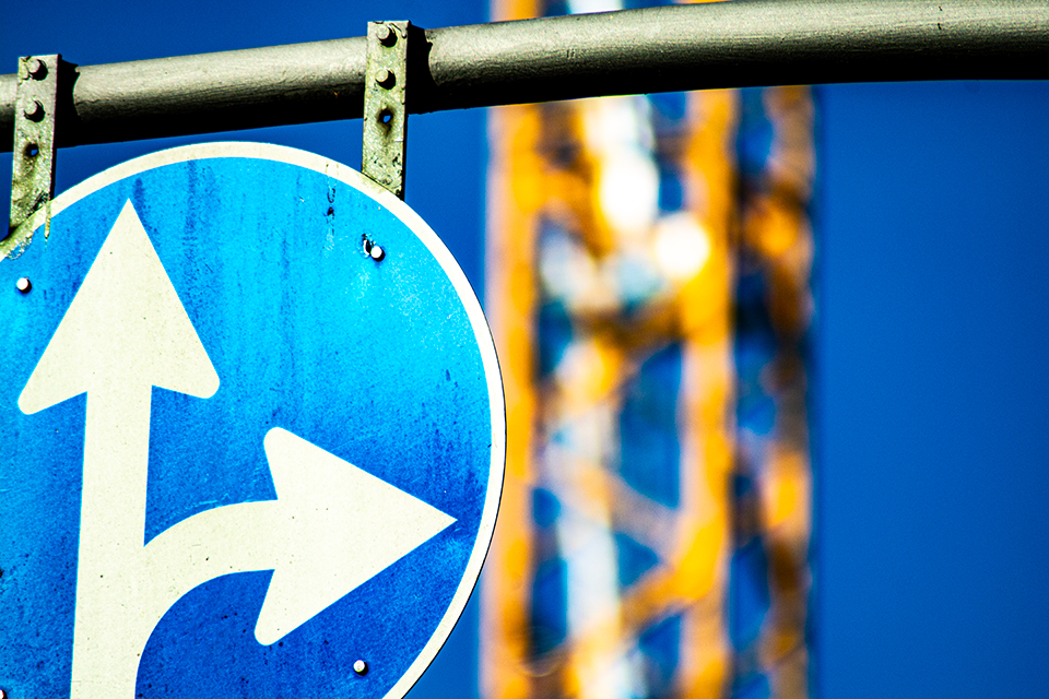 Photo of traffic sign with crane behind